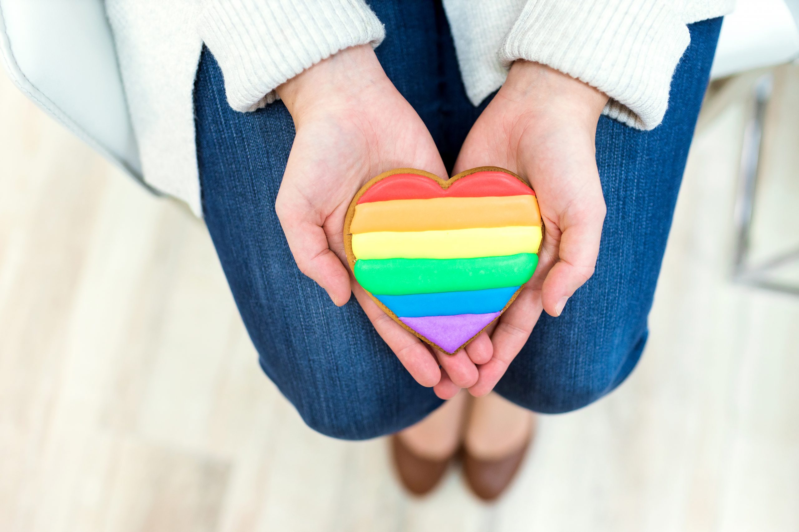A rainbow-striped cookie is held in a therapist's hands at Couples Reconnect.